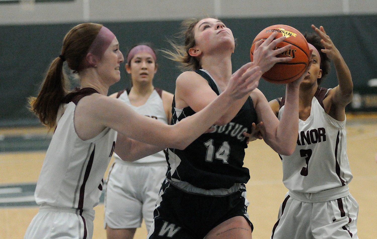 Cutting through the crowd. Not to be denied, Webutuck’s Olivia Farnham is on the way to scoring 15 points, despite the best defensive efforts of Manor’s Hailey Wolcott, Jocelyn Mills and Nevaeha Jones.